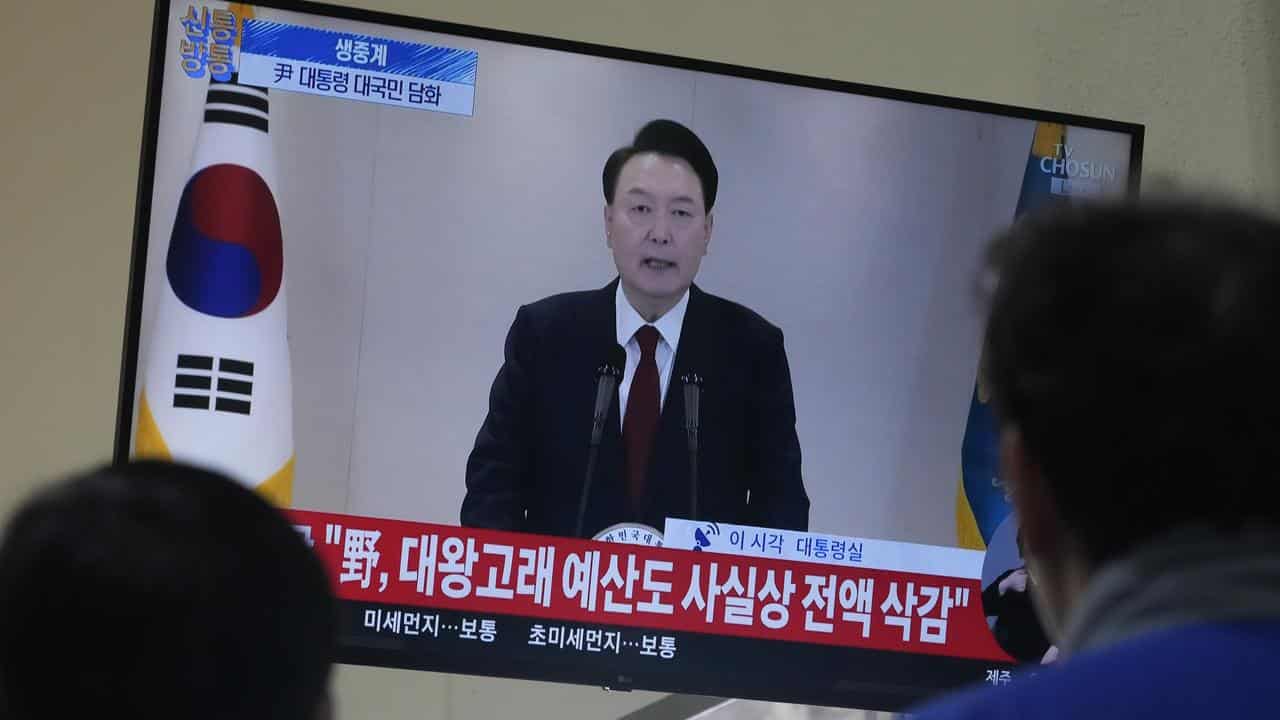 People watch a TV screen showing President Yoon Suk Yeol (file image)