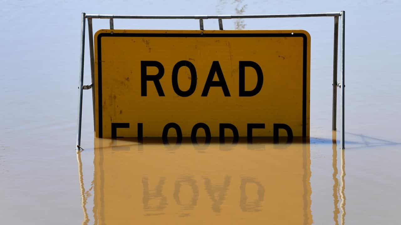 Road flooded sign partially submerged