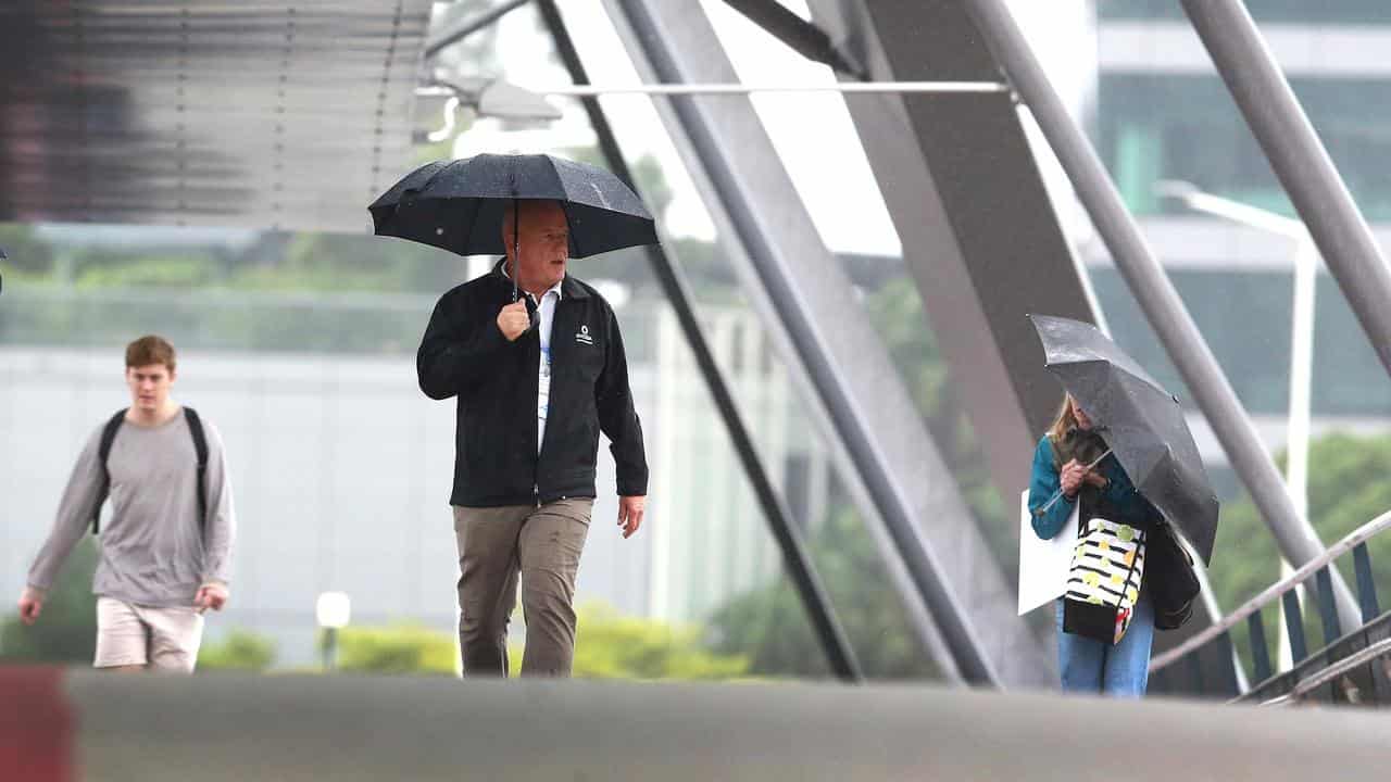 Pedestrians walk during rain in Brisbane (file image)