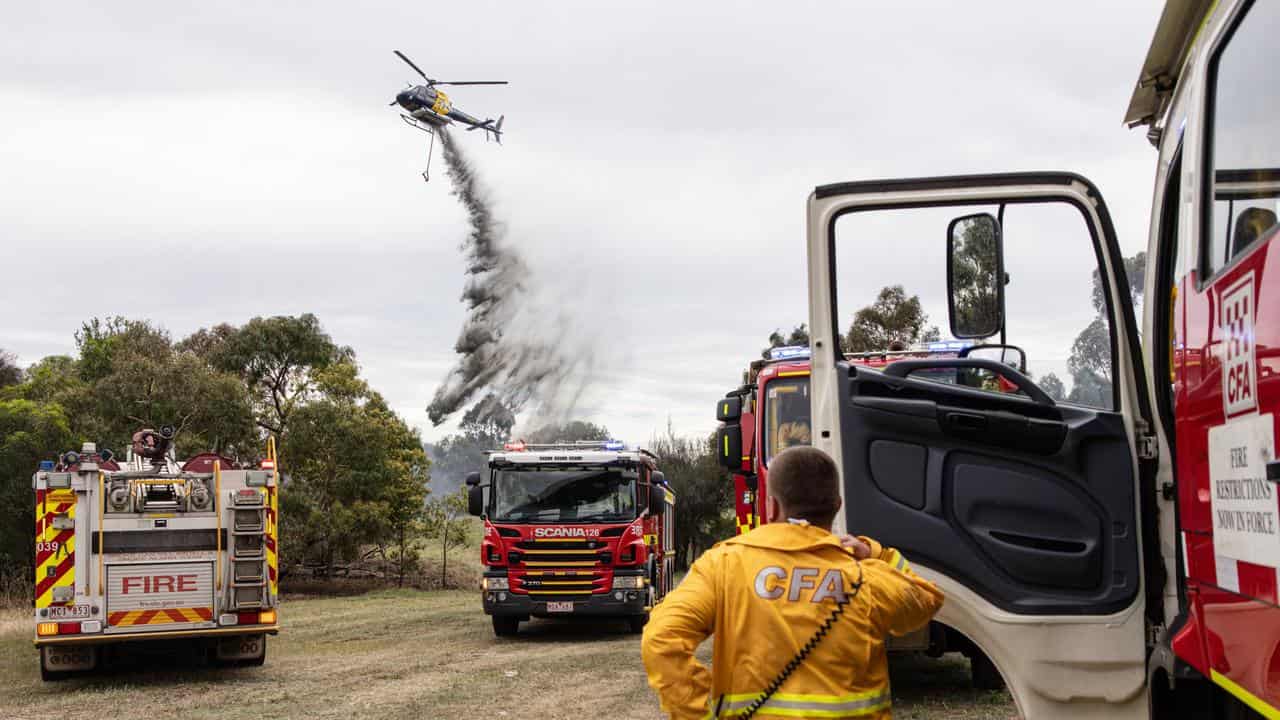 Firefighters battle a grassfire at Westgate Park in Melbourne