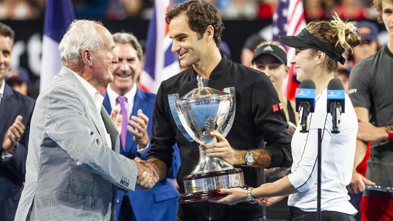 Neale Fraser presents the Hopman Cup to Roger Federer