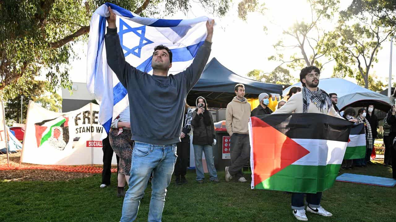 Peoiple hold Israeli and Palestinian flags (file image)