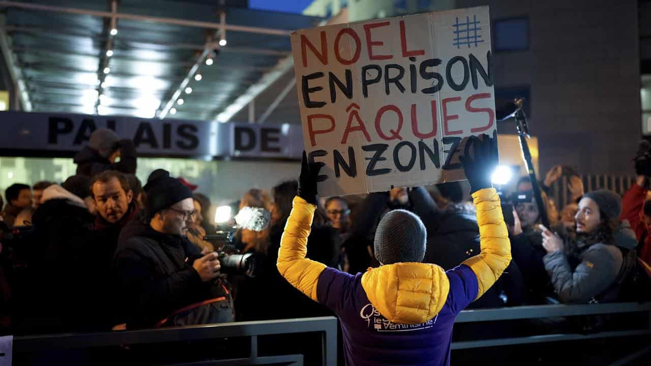 A protester outside court in Avignon, France