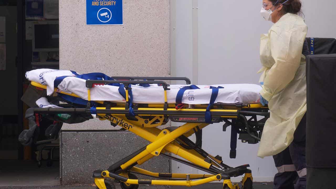 A paramedic with a stretcher outside a Melbourne Hospital.