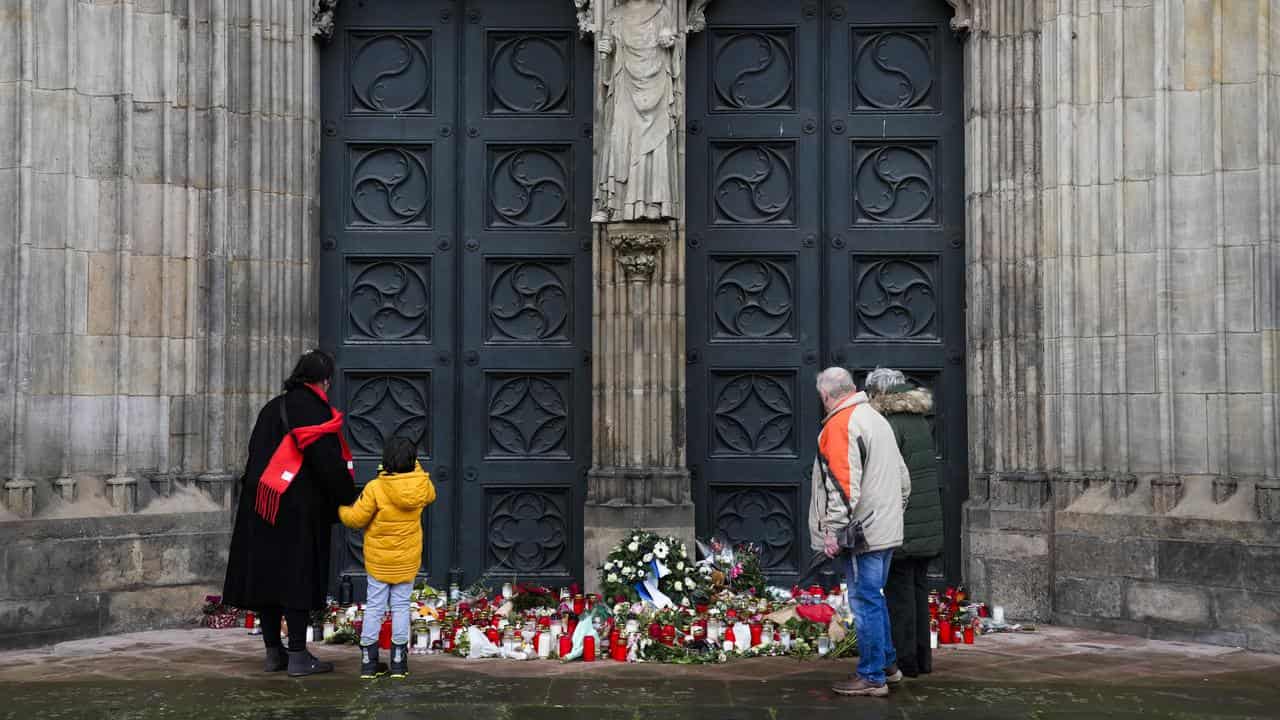 Flowers and candles laid down in front of the Magdeburg Cathedral