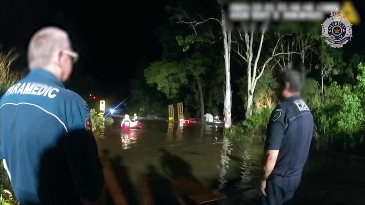 Police rescue a man from floodwaters