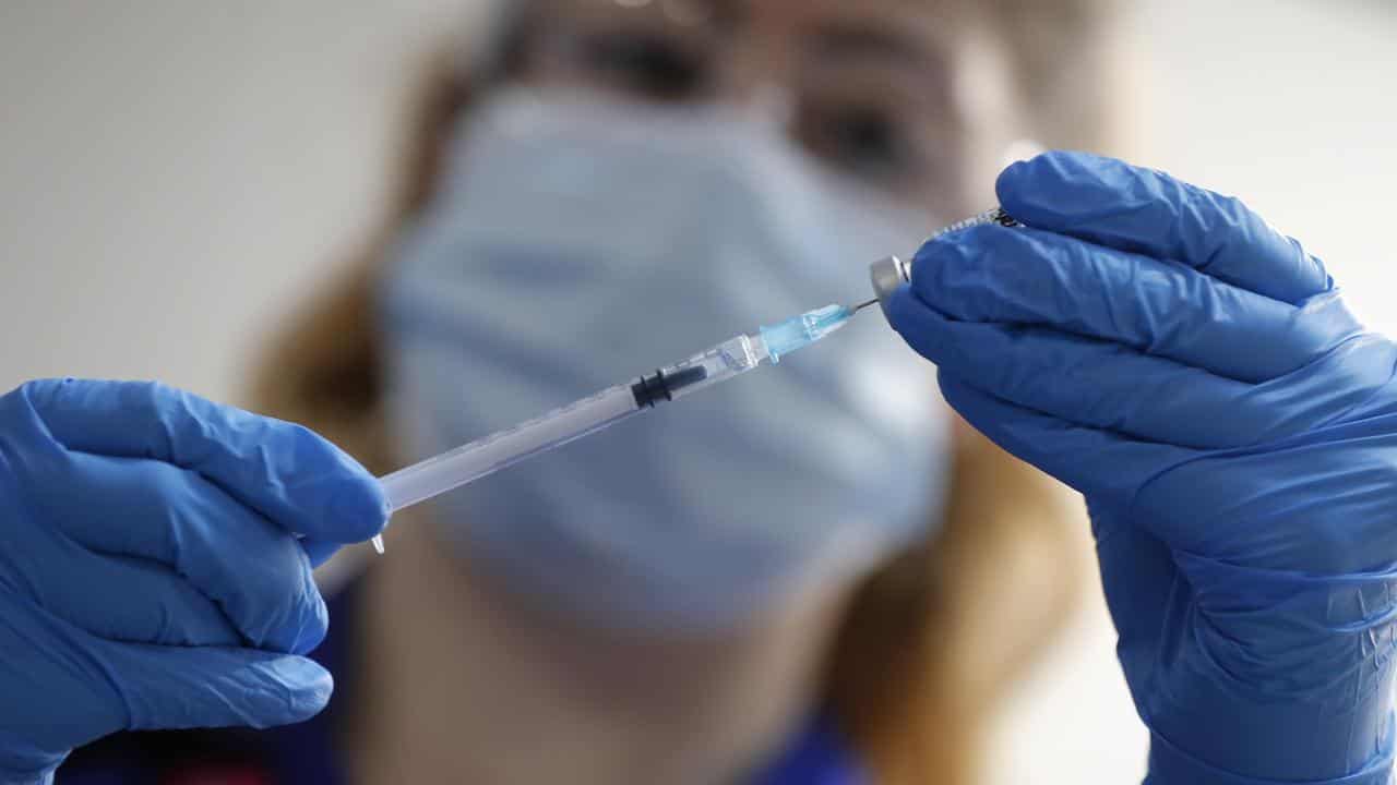 A nnurse prepares a COVID-19 vaccination.