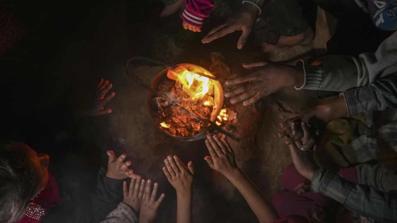 A displaced Palestinian family at a camp in Khan