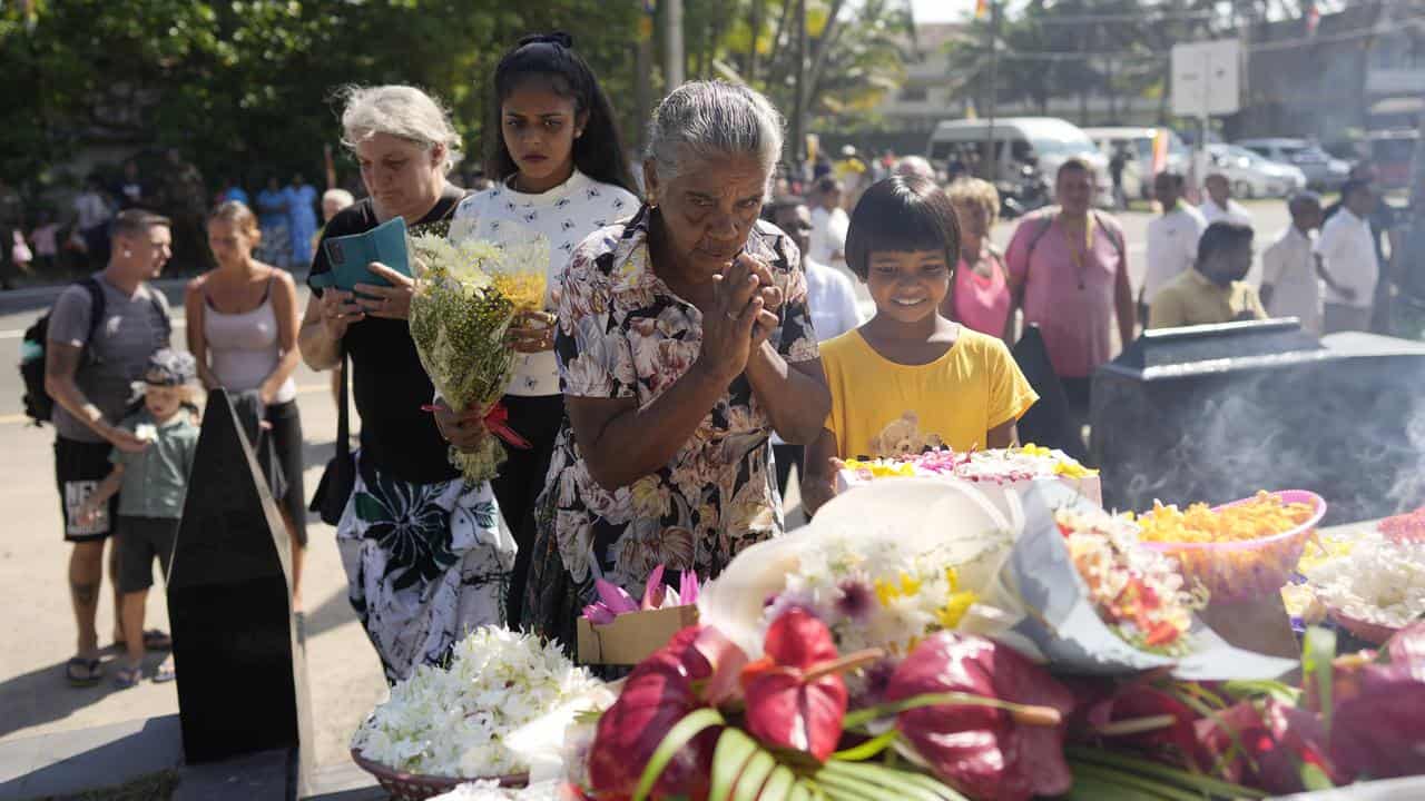 Relatives of tsunami victims offer tributes in Peraliya, Sri Lanka