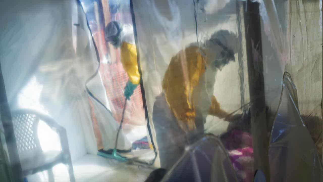 Health workers tend to an Ebola patient in Congo.