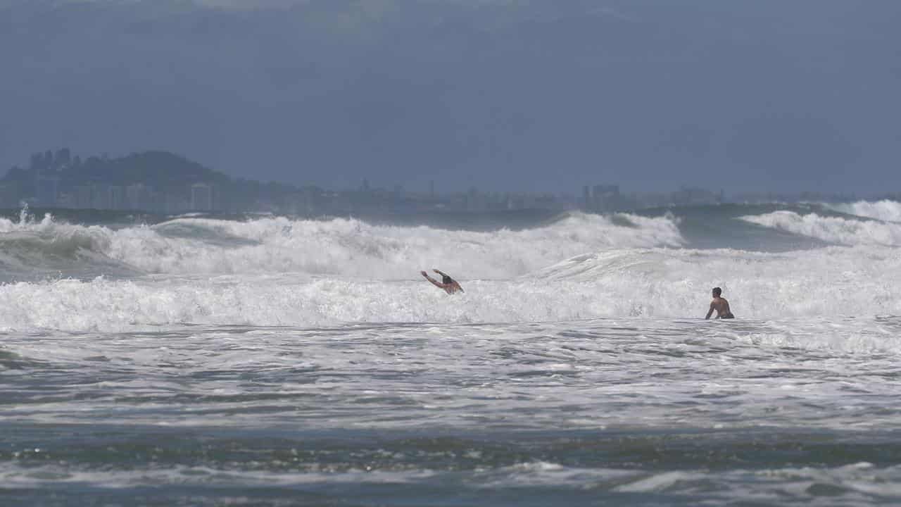 Swimmers in rough surf