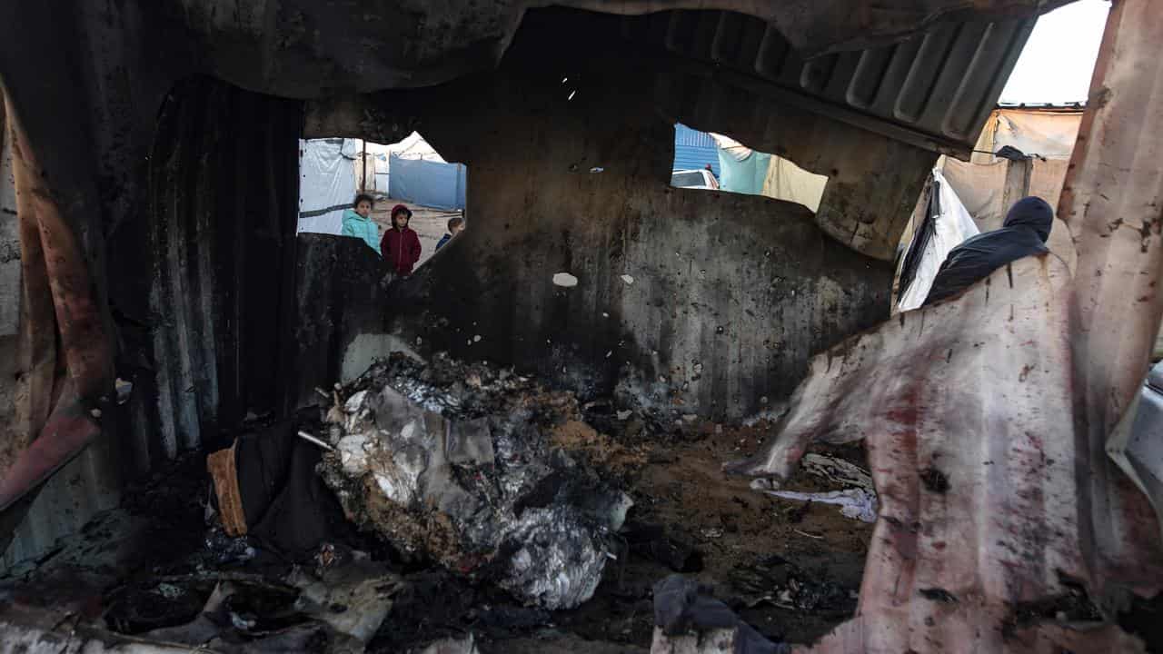 Children inspect damage after an Israeli air strike