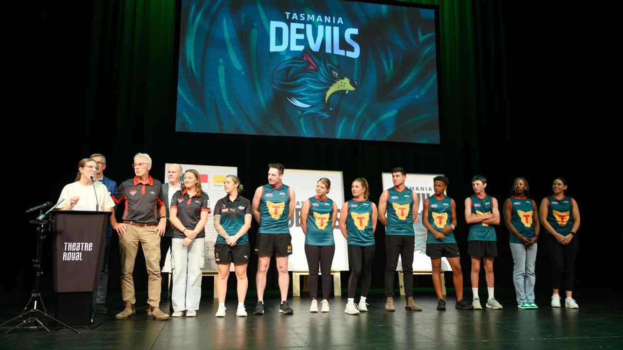 The Tasmanian Devil's guernsey is revealed.