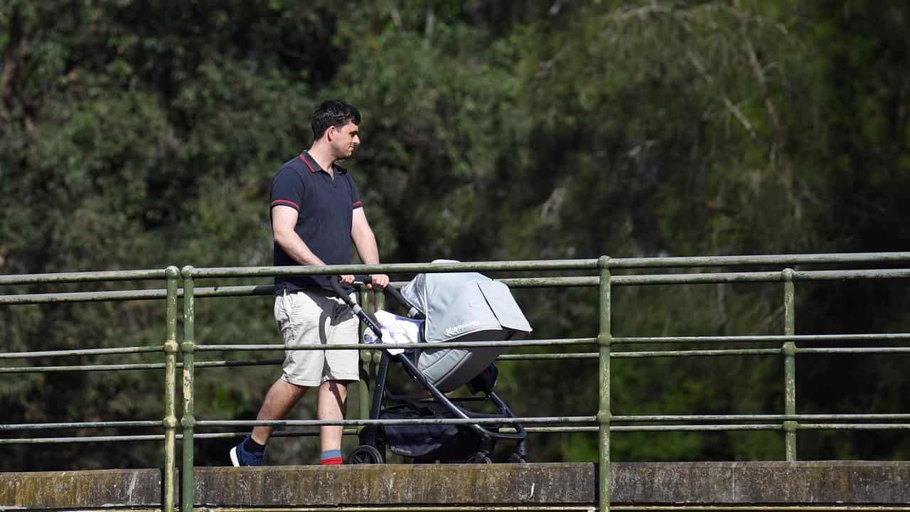 A man pushing a pram