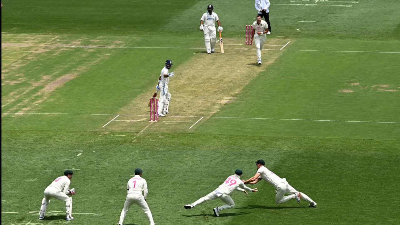 Virat Kohli is caught batting on a green pitch on day one.