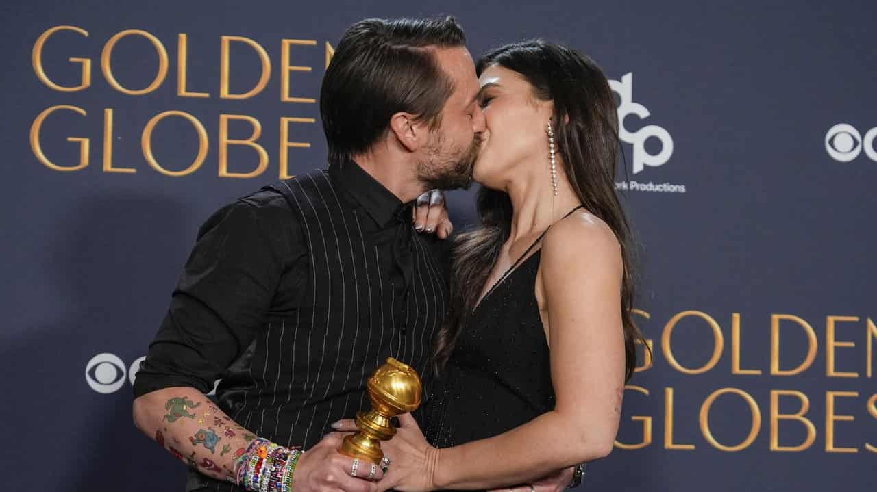 Keiran Culkin kisses wife Jazz Charton while holding his Golden Globe