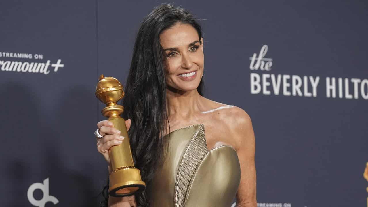 Demi Moore with her Golden Globe award