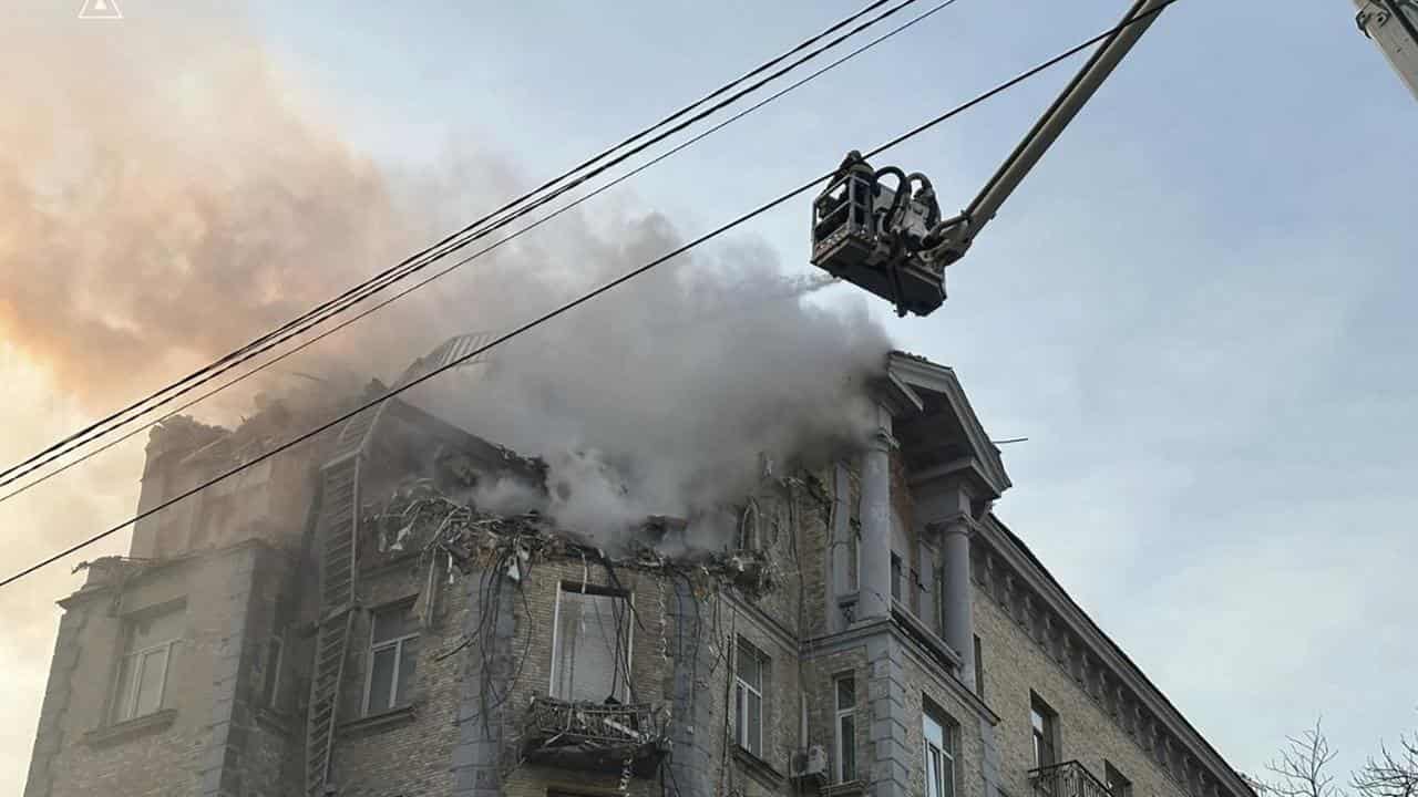 Rescue workers put out the fire of a residential building in Kyiv