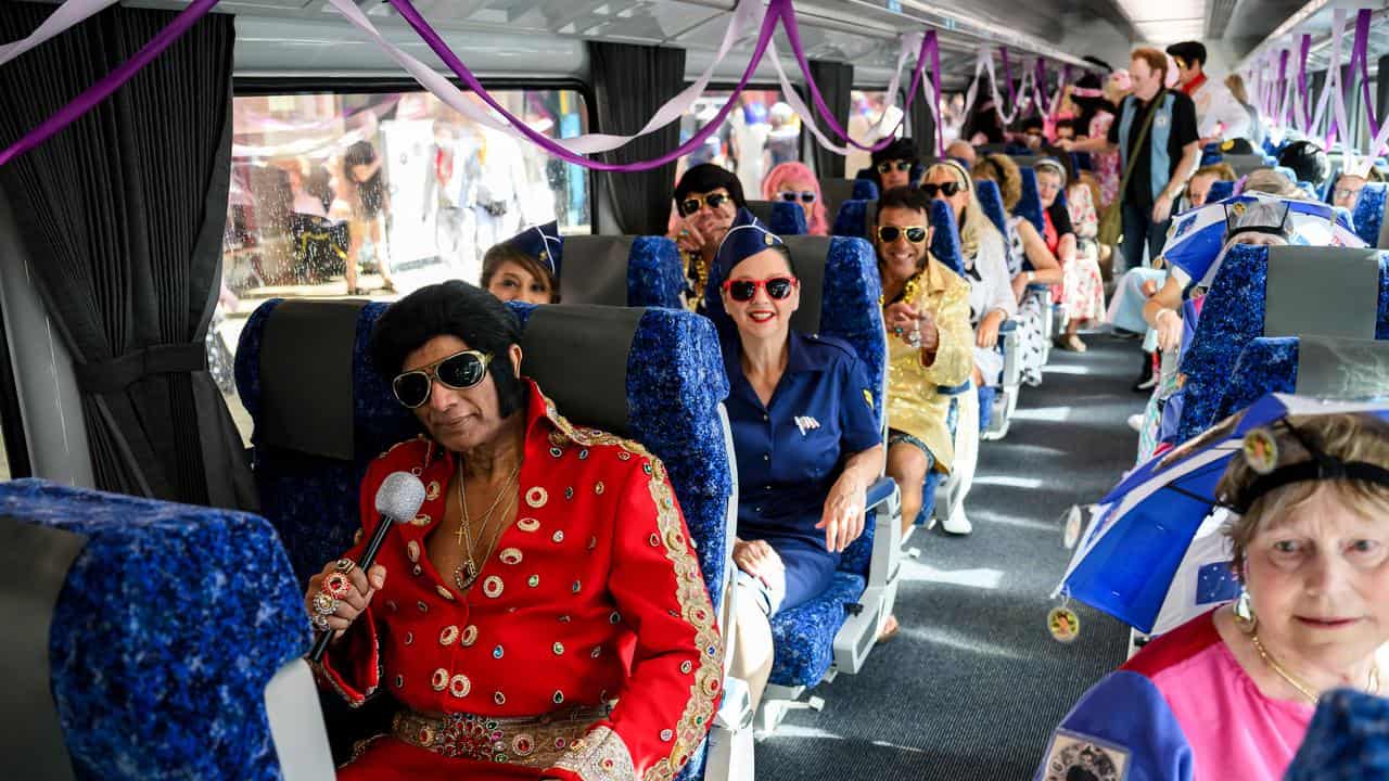 Fans wear Elvis Presley themed clothing onboard the Elvis Express