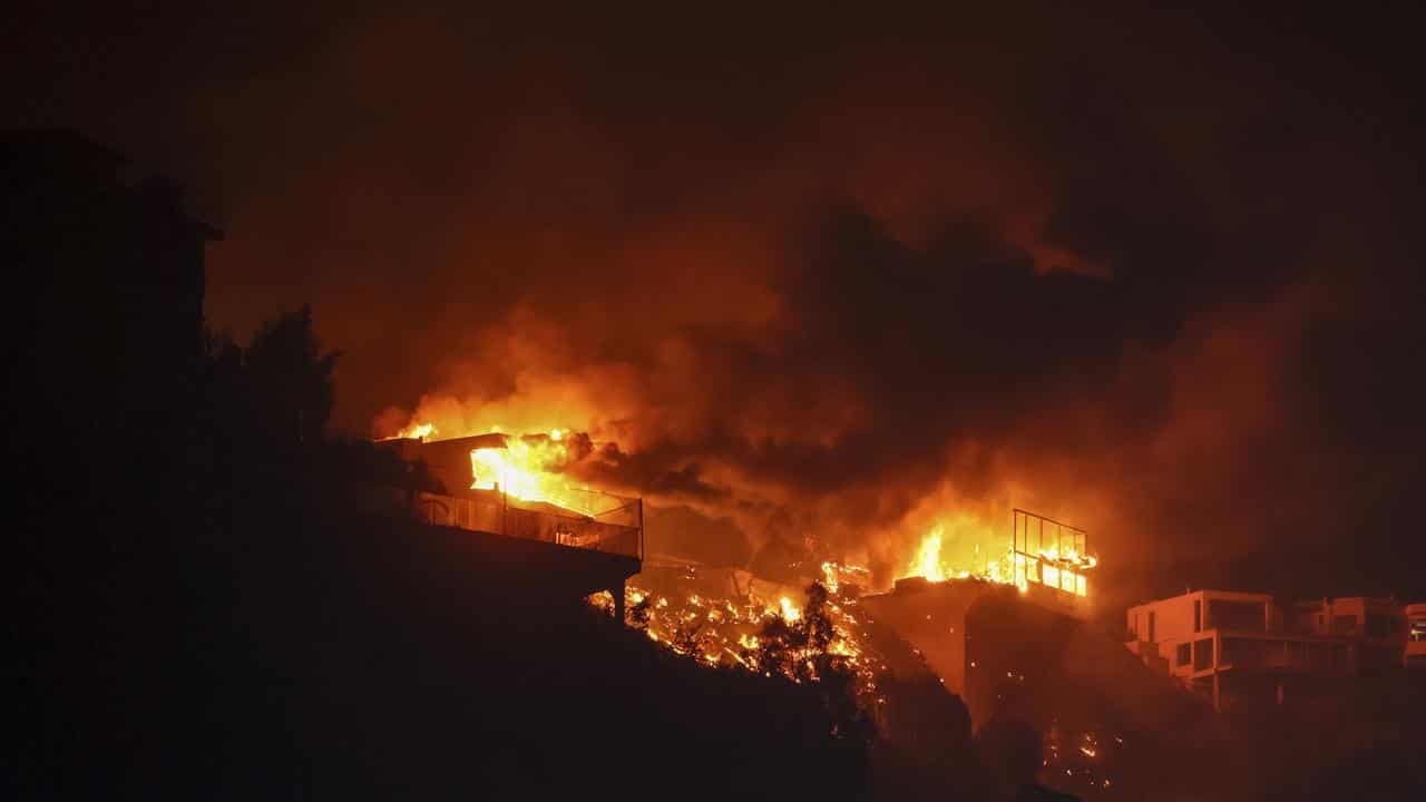 The Palisades Fire burns houses in the hill next to the Getty Villa