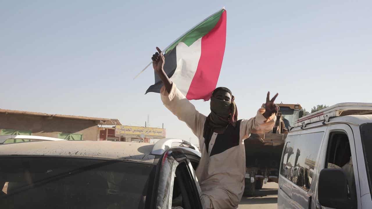 A Sudanese man does the peace sign