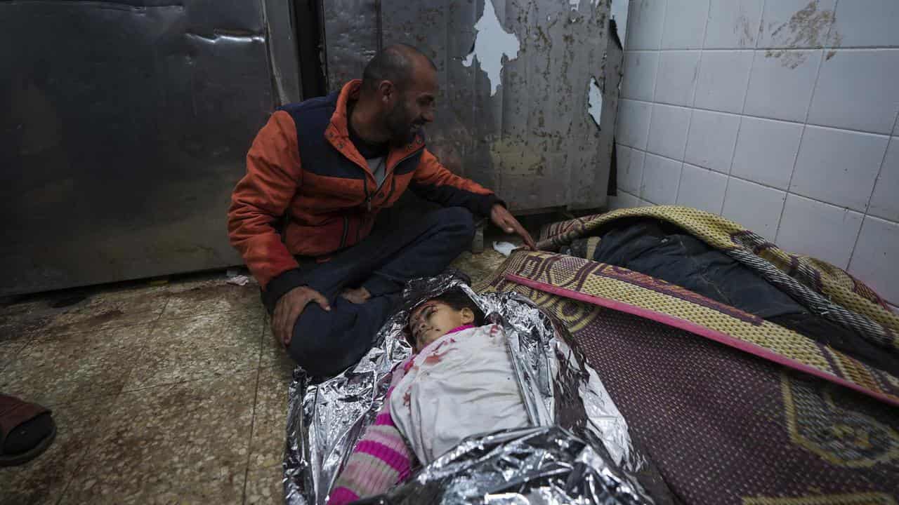 A father mourns his daughter,  killed in an Israeli airstrike,