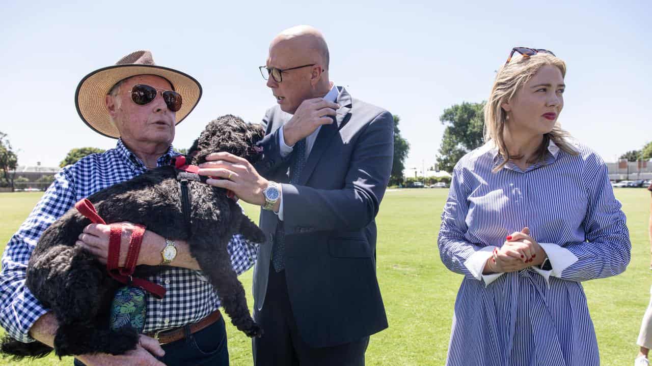 Australian Opposition Leader Peter Dutton strokes a dog