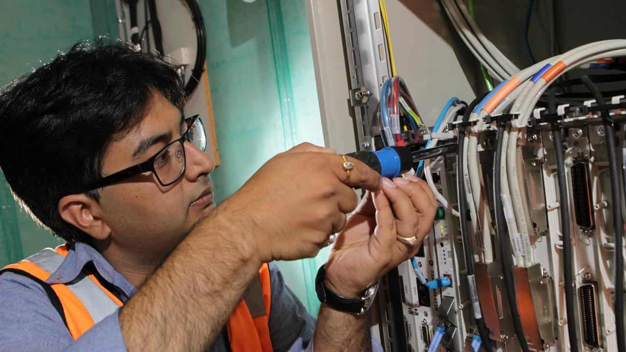 An NBN technician connects a building to the network (file image)