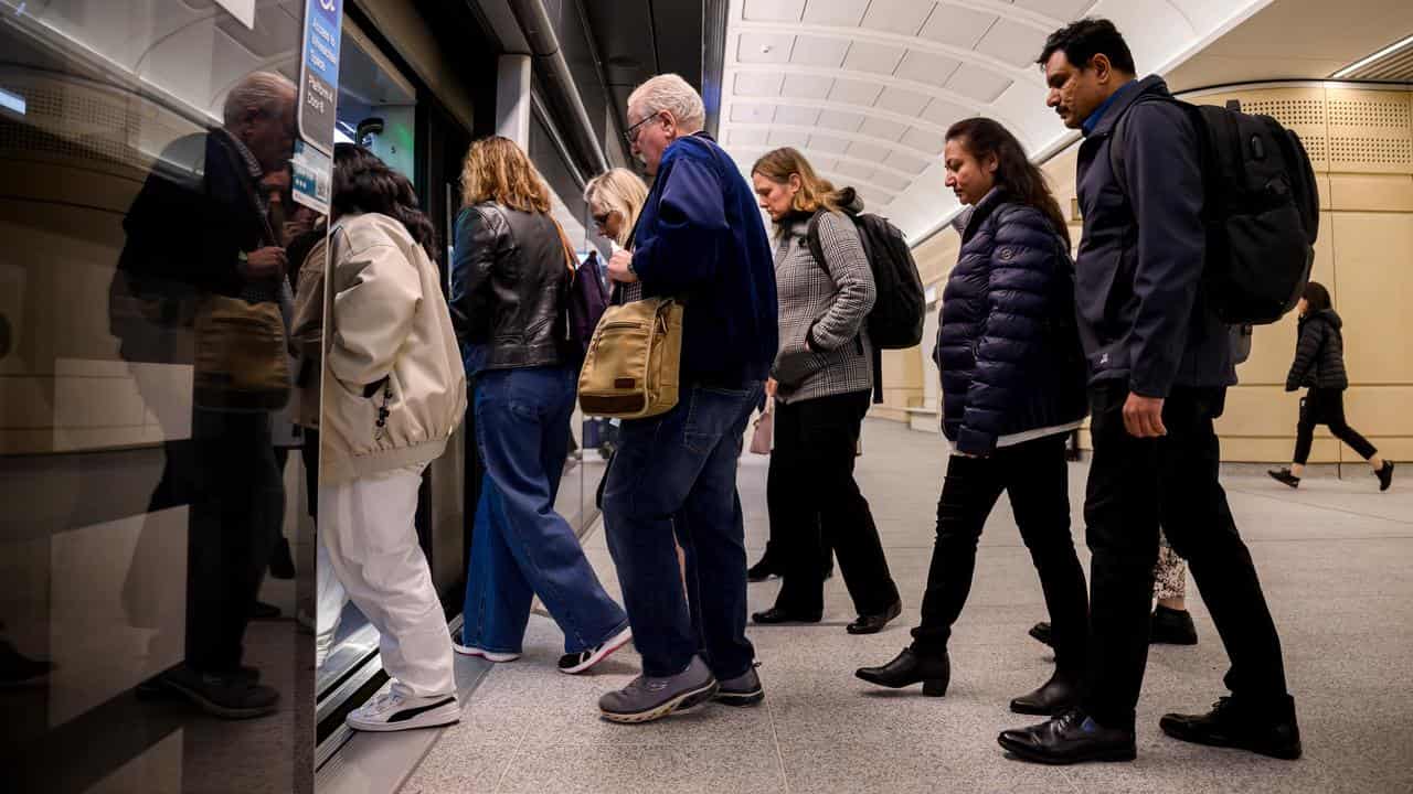 Commuters enter a train at Martin Place (file)