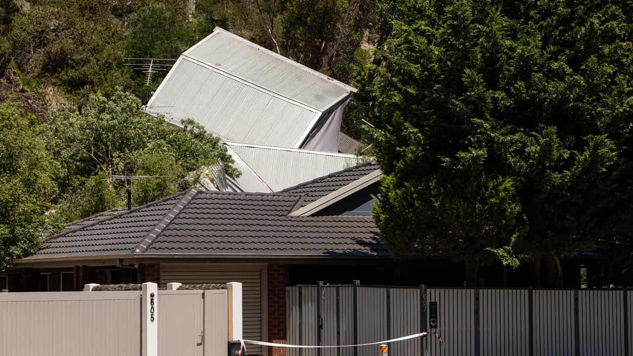 A house collapsed down a cliff in McCrae