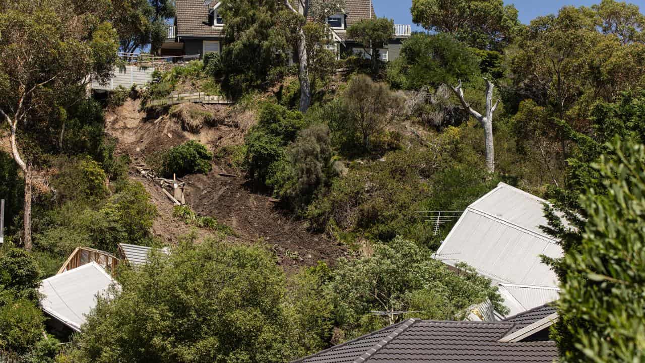 A house collapsed down a cliff in McCrae