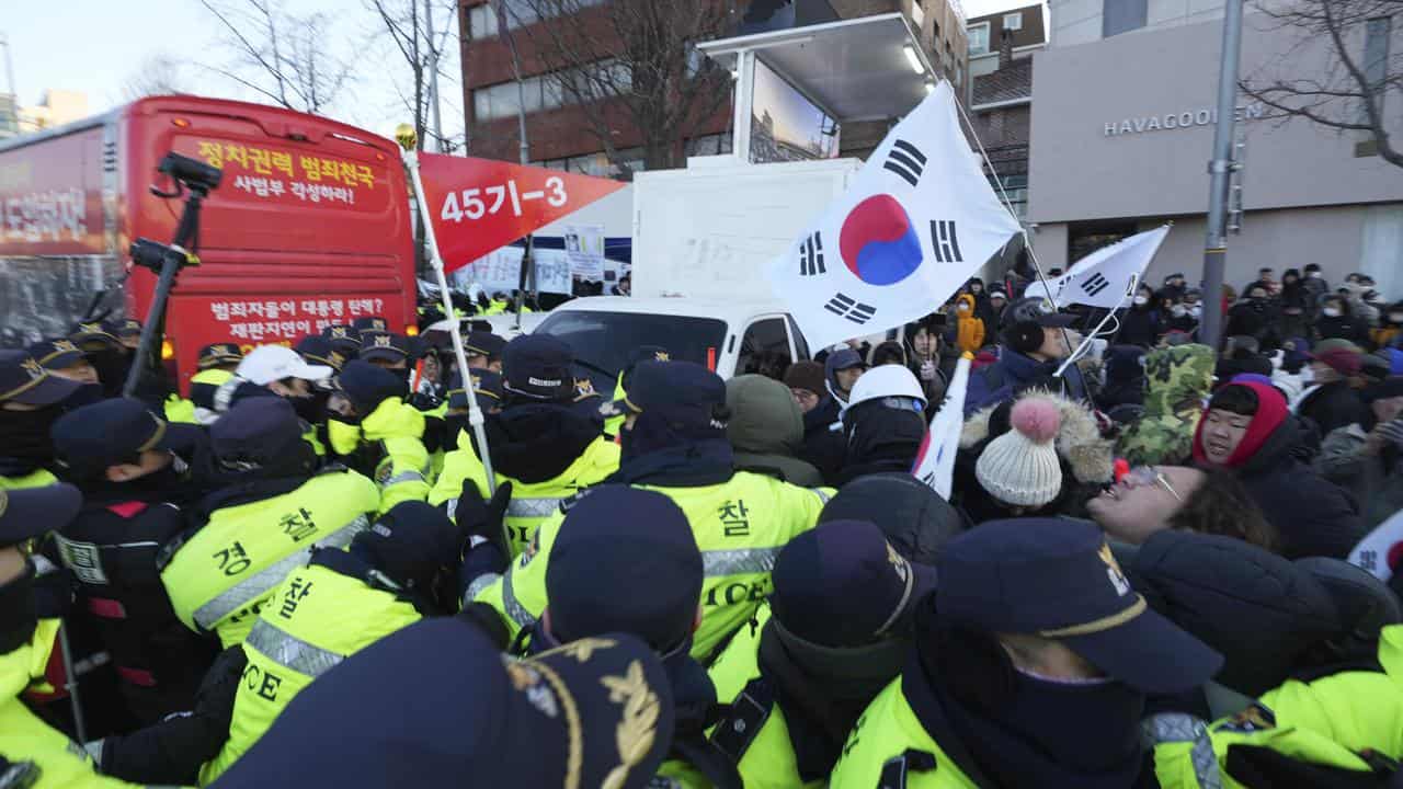 Supporters of Yoon Suk-yeol react as police officers try to block them