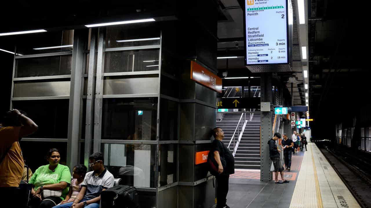 Commuters await the arrival of a train at Town Hall Station