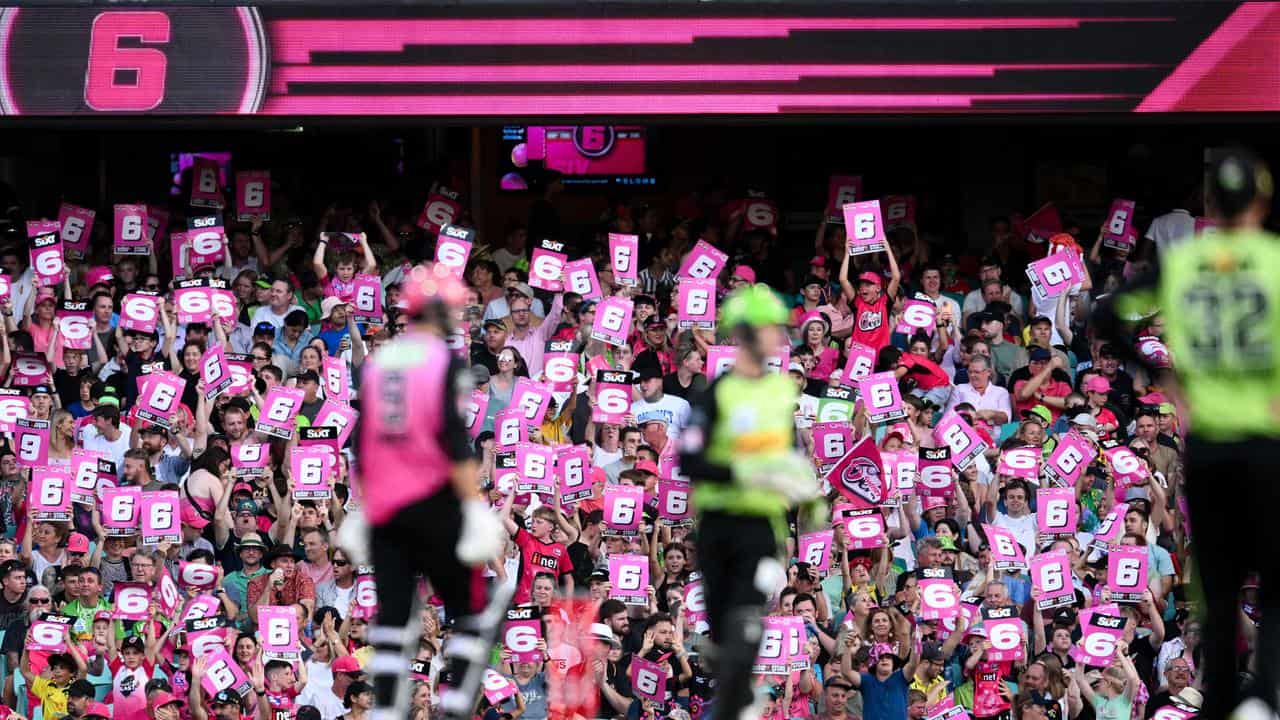 The crowd hold up signs during the BBL