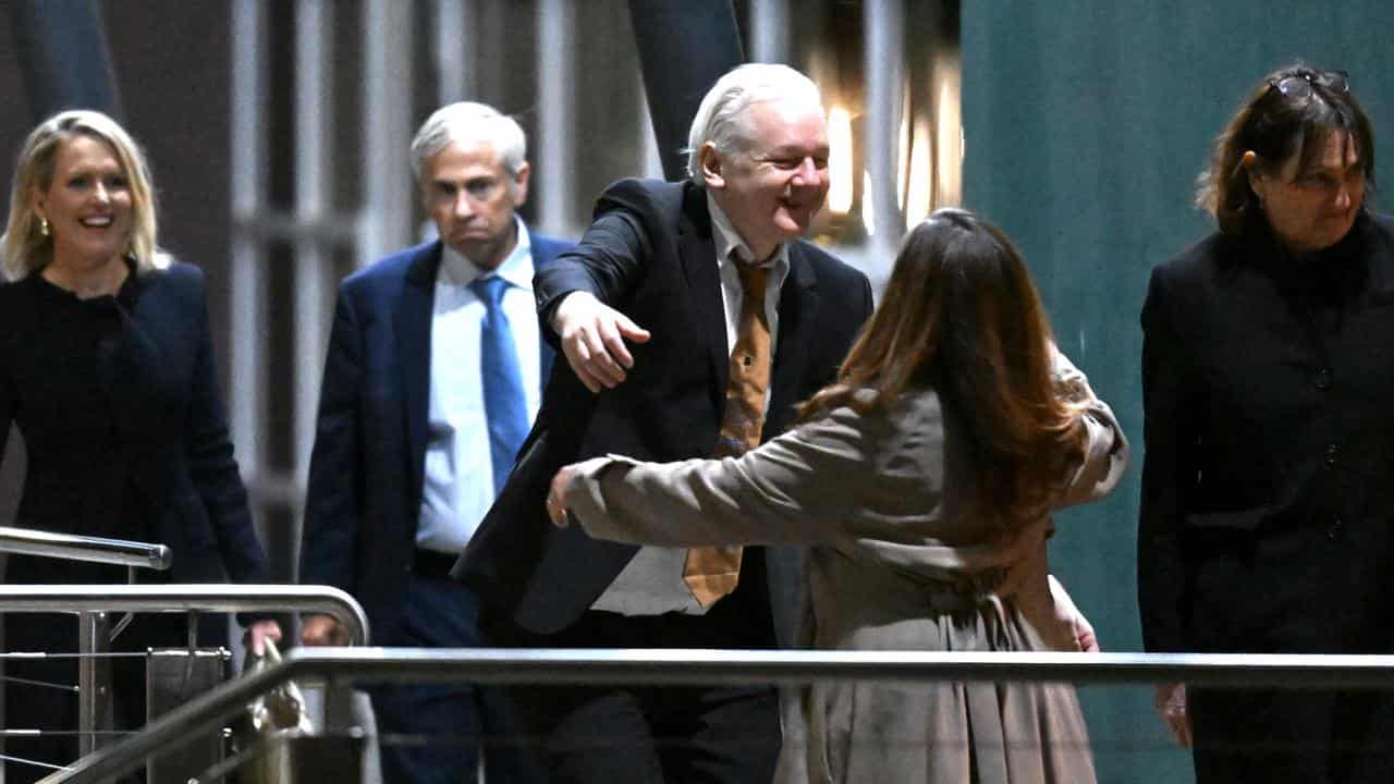 Julian Assange greeting his wife after arriving at Canberra Airport