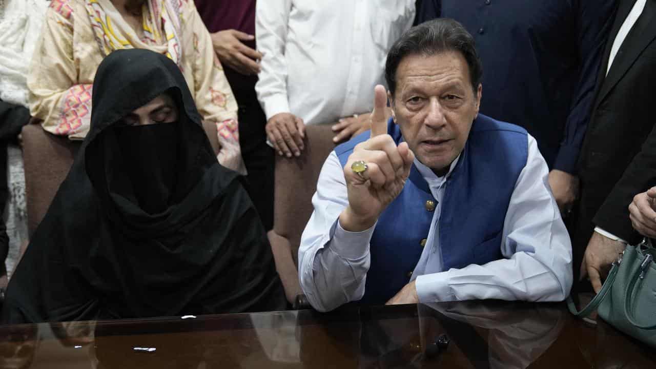 Imran Khan and wife Bushra Bibi (left)