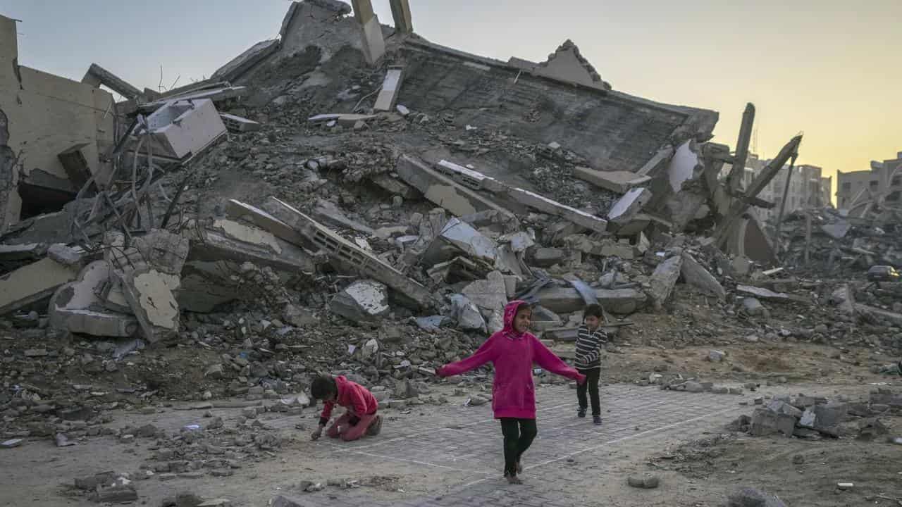 Children play next to a building destroyed by Israel's army in Gaza