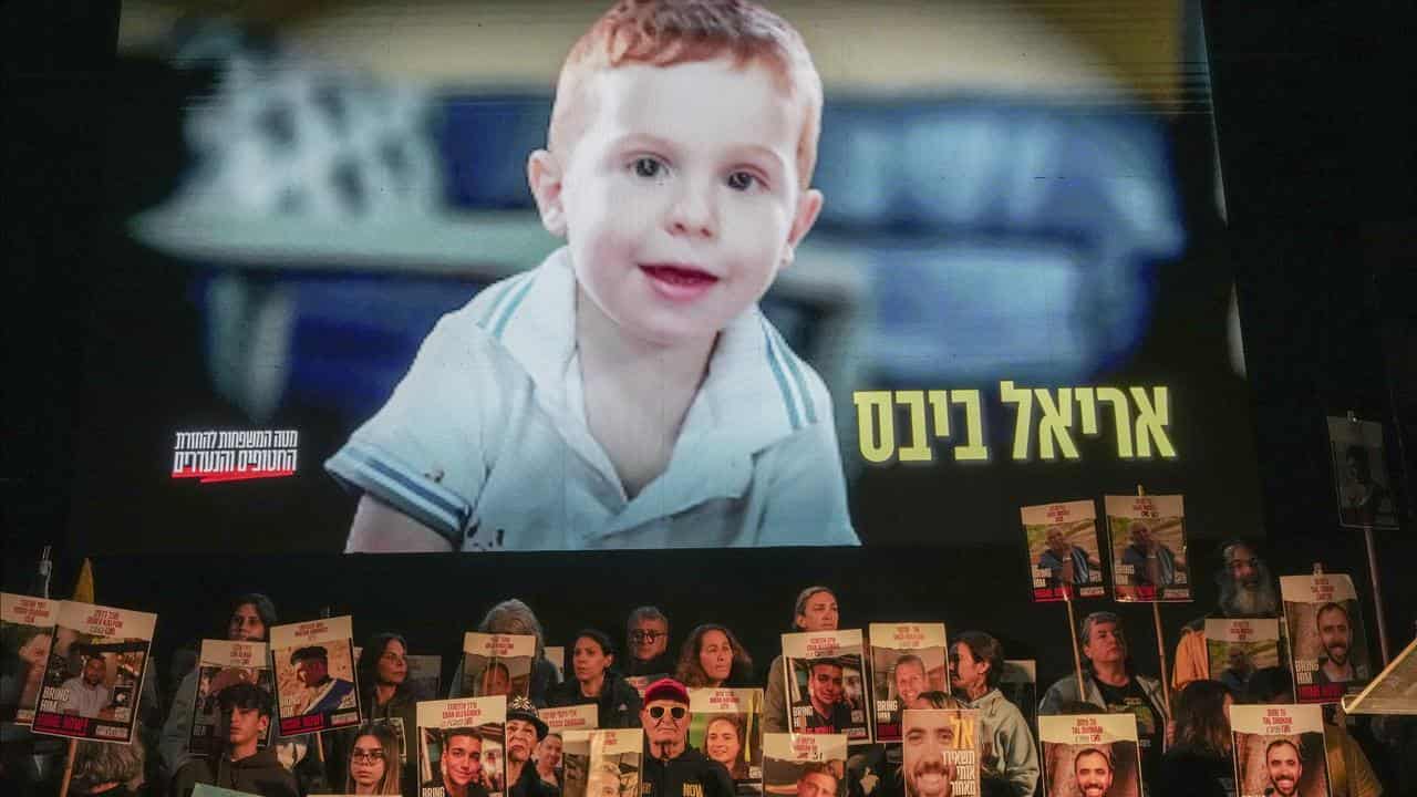 Demonstrators hold portraits of hostages held by Hamas in Gaza