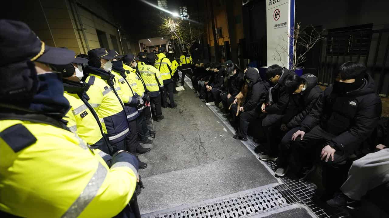 Police officers and supporters of South Korean President Yoon Suk-yeol