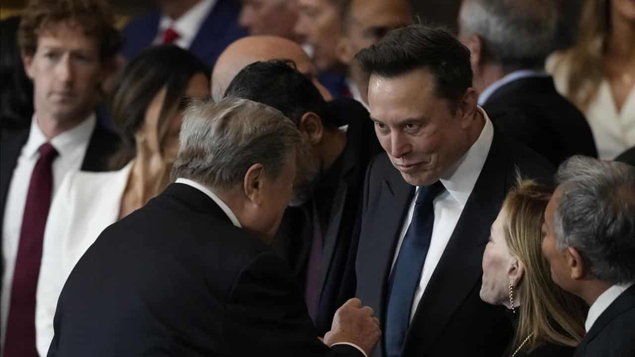 Viktor Knavs talks with Elon Musk before the Presidential Inauguration