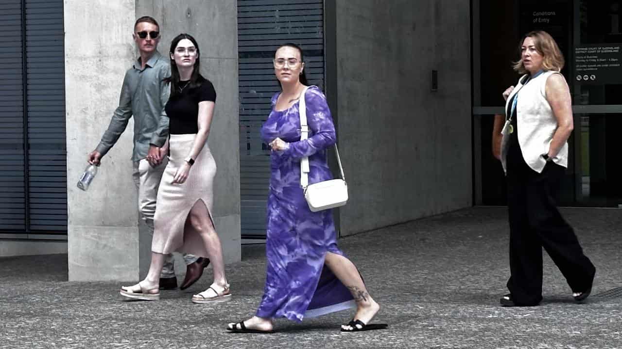 Daughter Olivia Godfrey (centre) leaves court