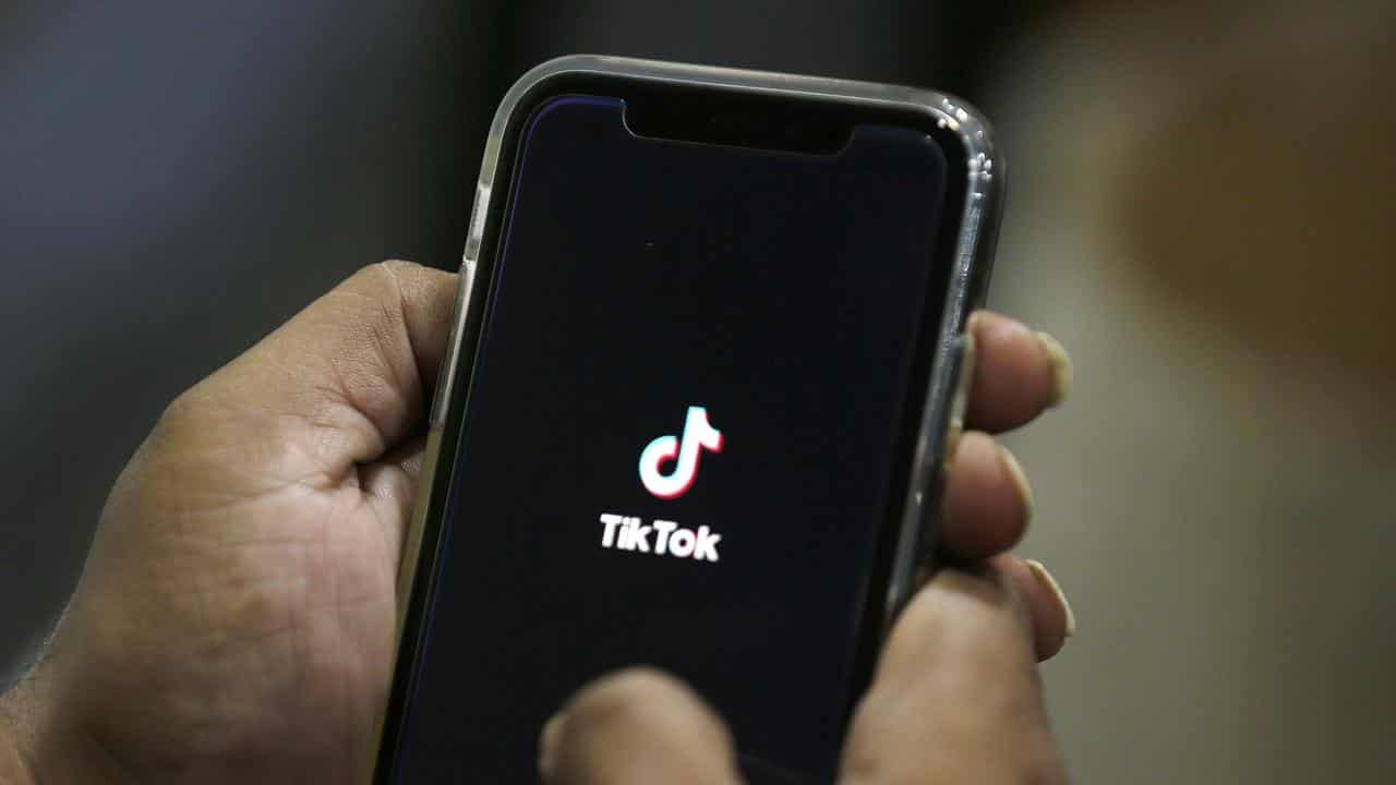 A person using TikTok on a mobile phone