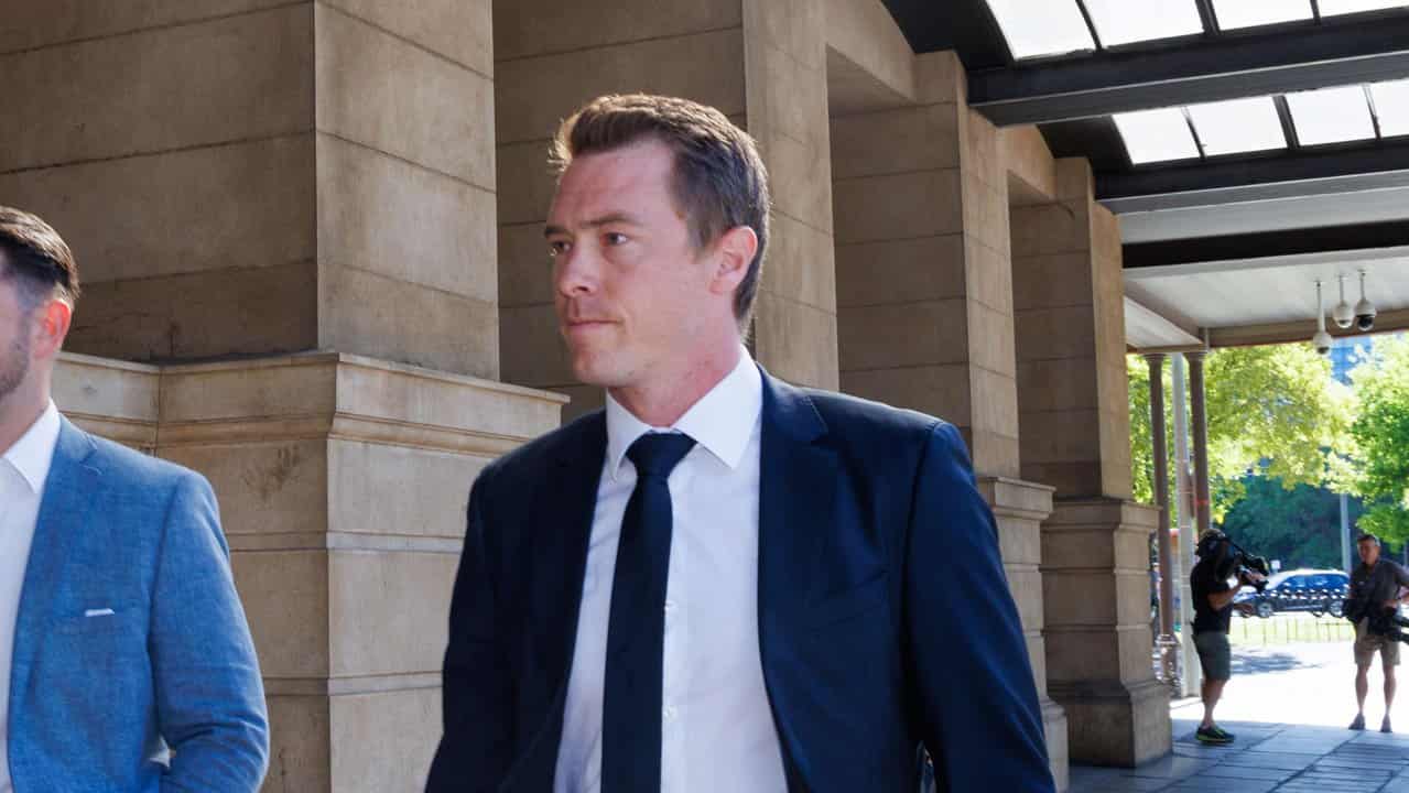 Rohan Dennis (right) leaves the Sir Samuel Way Building in Adelaide