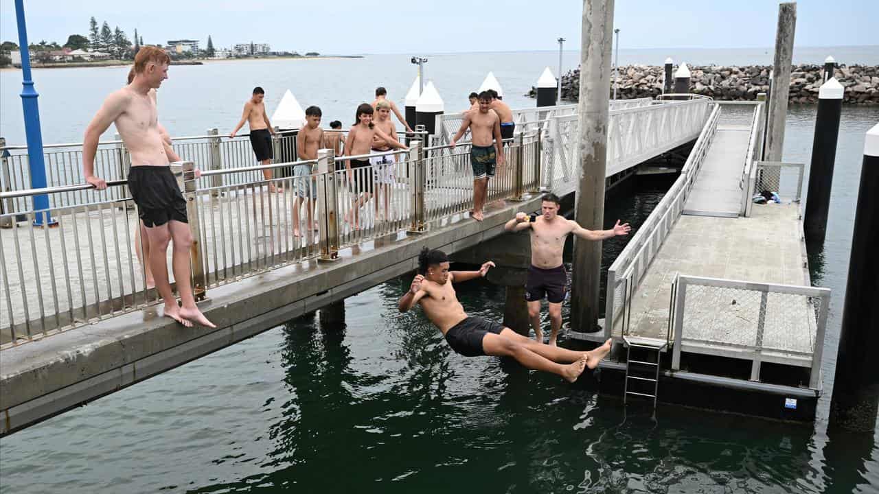 People are seen cooling off from the Redcliffe Jetty