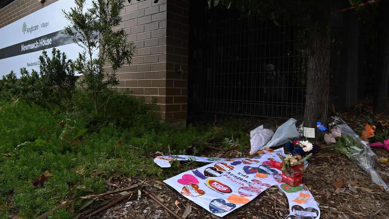 Signs and flowers at Newmarch House (file)