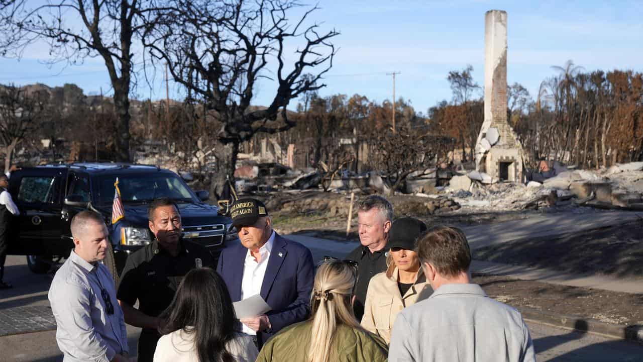 President Donald Trump and first lady Melania Trump talk to survivors