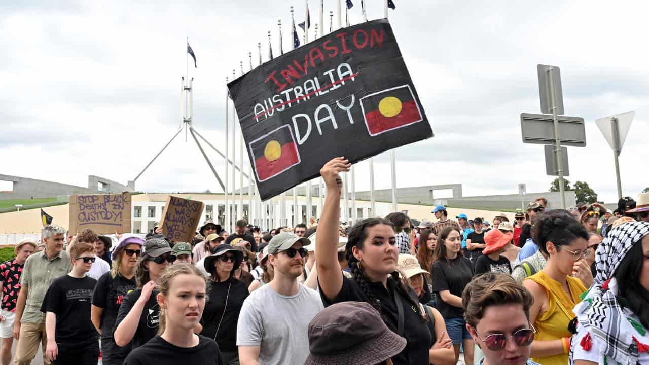 Protesters march past Parliament House