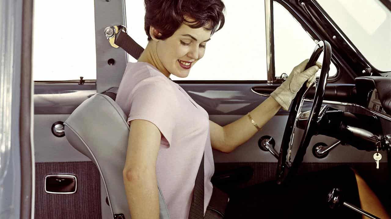 A 1960s ad showing the V-shaped seatbelt in use