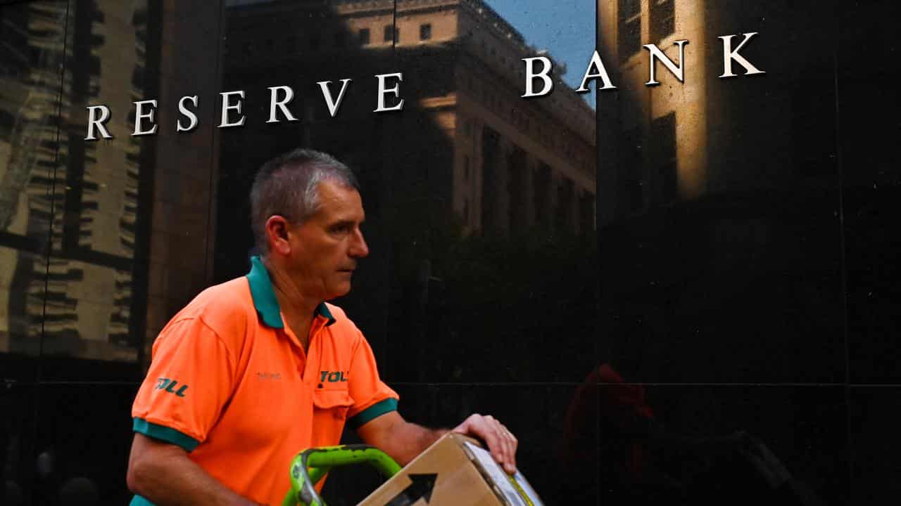 Courier walks past the Reserve Bank of Australia