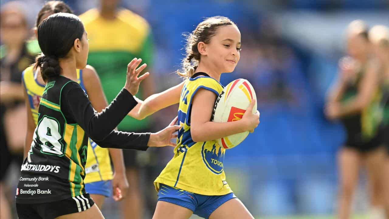 Children play a game of touch football